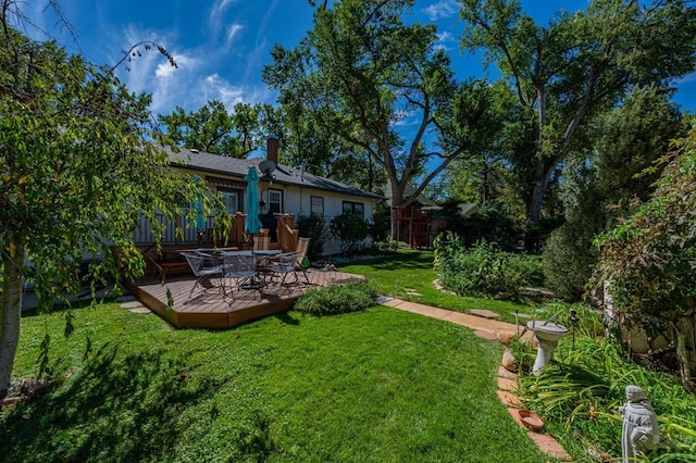 view of yard with a wooden deck