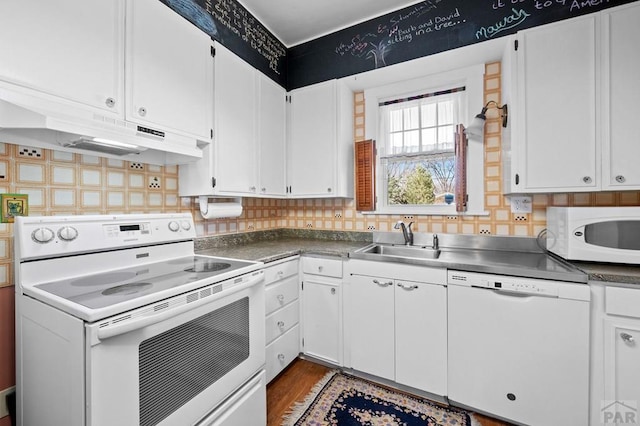 kitchen with white cabinetry, white appliances, under cabinet range hood, and a sink