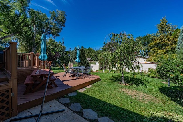 view of yard with a deck and outdoor dining space