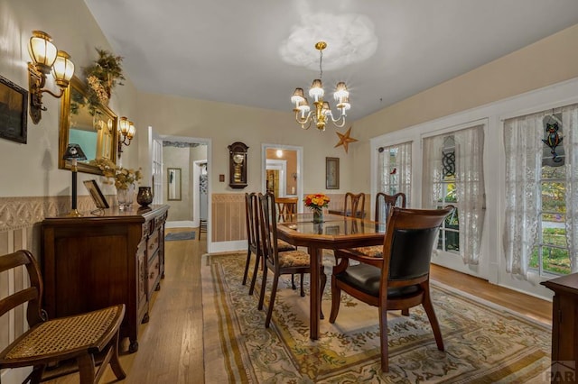 dining area with a notable chandelier and hardwood / wood-style flooring