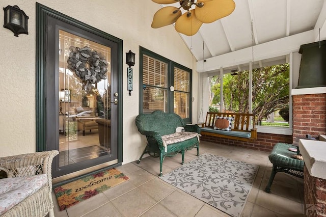 sunroom / solarium with ceiling fan and vaulted ceiling