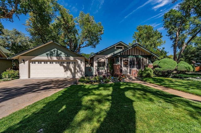 view of front of house with concrete driveway, a garage, brick siding, and a front yard