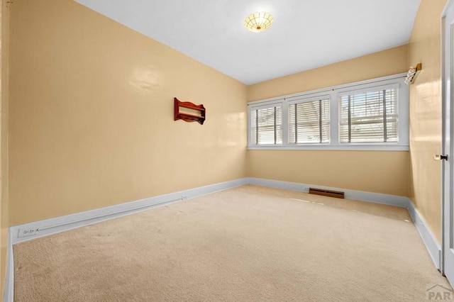 empty room with visible vents, baseboards, and carpet floors