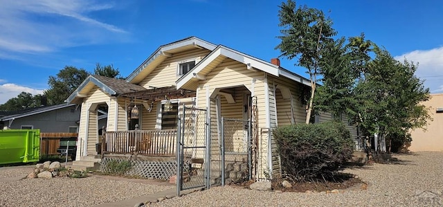 view of front of property with covered porch and fence