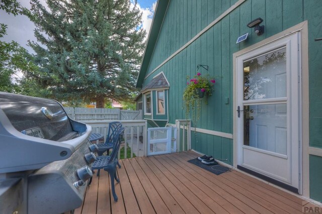 wooden terrace featuring a grill