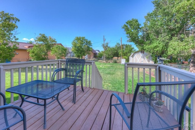 209 E Francisco St, La Veta, CO 81055 - wooden deck with a shed, a fenced backyard, a lawn, and an outbuilding
