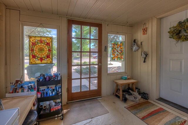 doorway to outside with wood ceiling