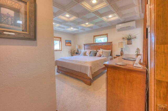 bedroom with coffered ceiling, multiple windows, carpet flooring, and a wall mounted AC