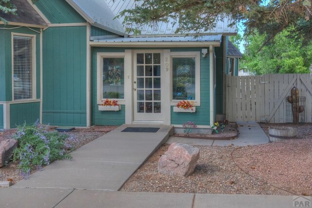 209 E Francisco St, La Veta, CO 81055 - entrance to property featuring board and batten siding, metal roof, and fence