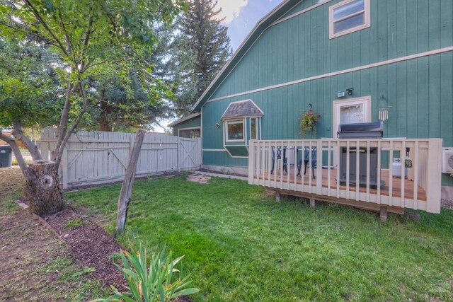 view of yard with fence and a deck