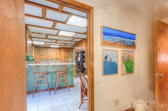 dining area featuring light tile patterned floors and bar