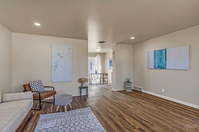 sitting room with dark wood finished floors, recessed lighting, baseboards, and visible vents