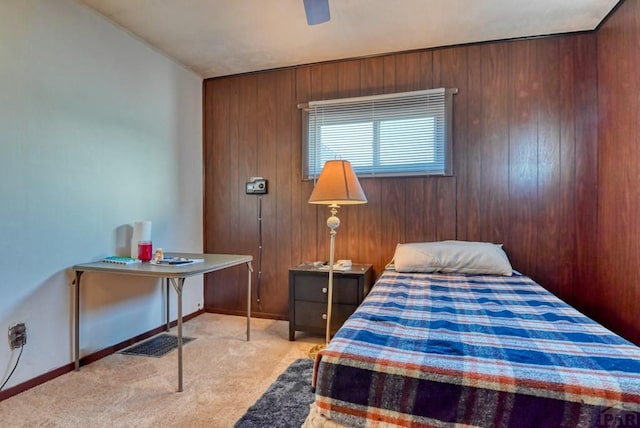 bedroom featuring baseboards, wood walls, visible vents, and light colored carpet