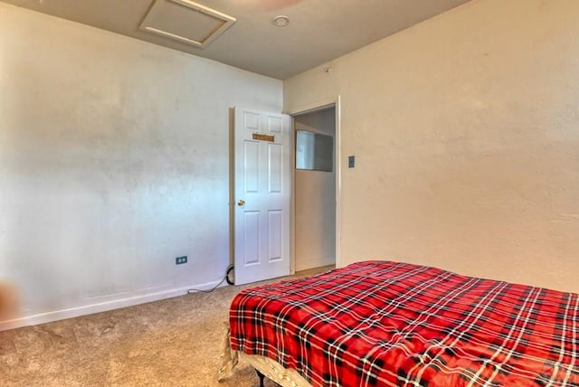 carpeted bedroom with attic access and baseboards