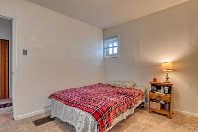 bedroom with light carpet, baseboards, and visible vents