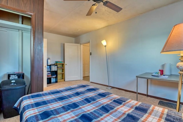 bedroom with light carpet, ceiling fan, and baseboards