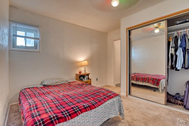 bedroom featuring baseboards, a ceiling fan, a closet, and carpet flooring