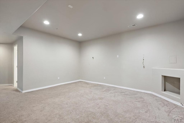 1121 N Calico Rock Ln, Pueblo West, CO 81007 - carpeted empty room featuring recessed lighting, baseboards, and a fireplace