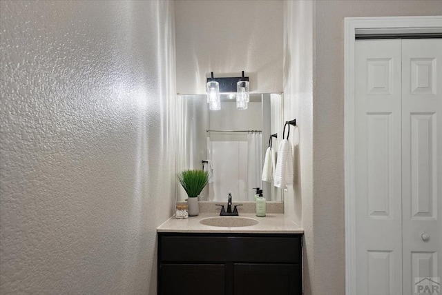 1121 N Calico Rock Ln, Pueblo West, CO 81007 - bathroom featuring a closet, a textured wall, and vanity