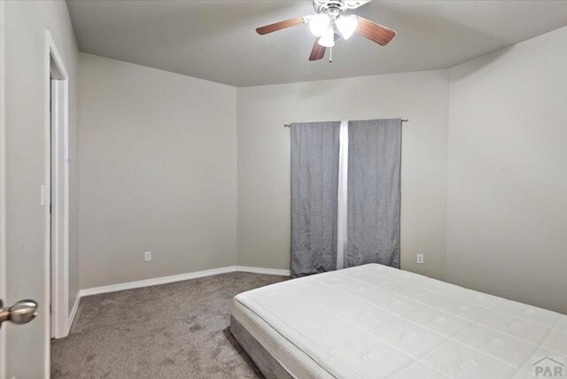 1121 N Calico Rock Ln, Pueblo West, CO 81007 - carpeted bedroom featuring baseboards and a ceiling fan