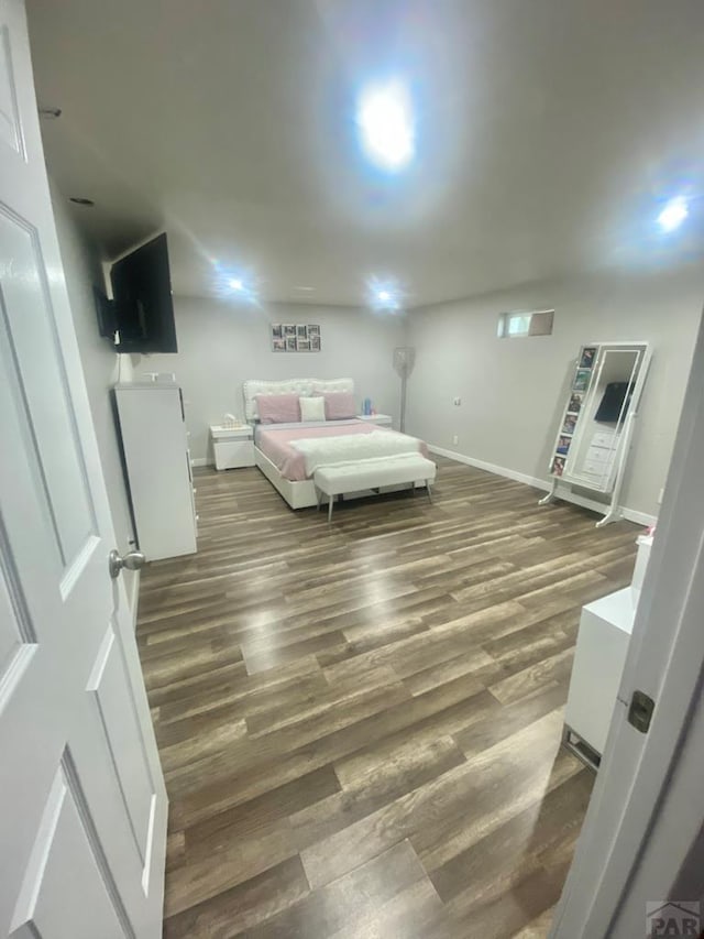 bedroom with wood finished floors and baseboards