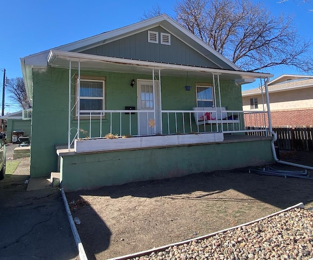 back of property with covered porch