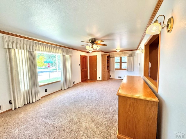 1645 Cherrywood Ln, Pueblo, CO 81005 - unfurnished living room with ornamental molding, light carpet, and ceiling fan