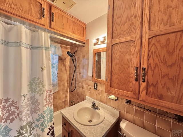 1645 Cherrywood Ln, Pueblo, CO 81005 - full bath with vanity, tile walls, tasteful backsplash, and shower / tub combo with curtain