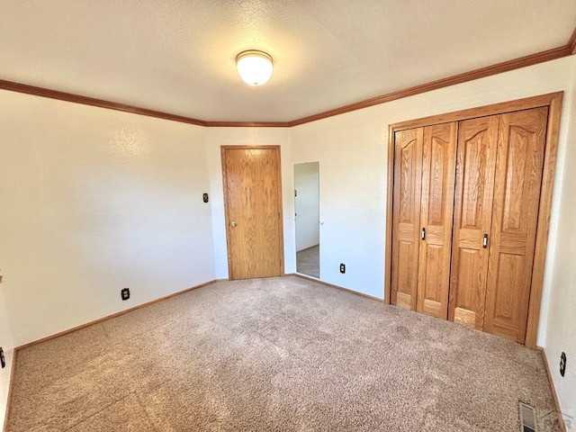 1645 Cherrywood Ln, Pueblo, CO 81005 - unfurnished bedroom with carpet, crown molding, a closet, and a textured ceiling