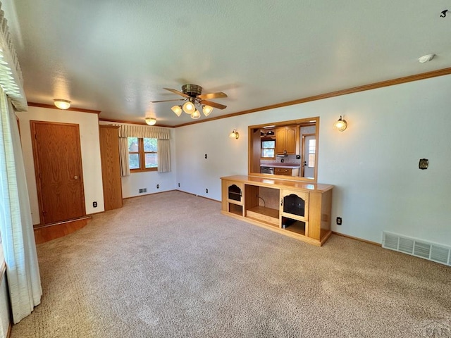 1645 Cherrywood Ln, Pueblo, CO 81005 - unfurnished living room featuring a ceiling fan, crown molding, and carpet flooring