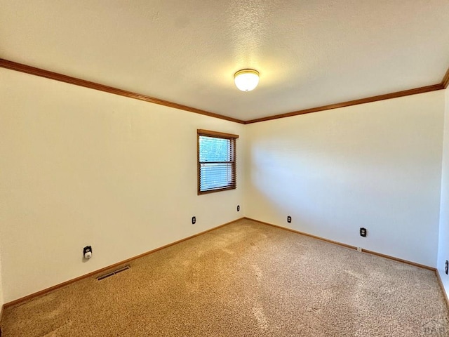 1645 Cherrywood Ln, Pueblo, CO 81005 - empty room with light carpet, crown molding, and a textured ceiling