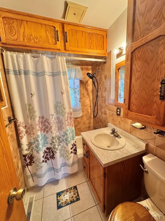 1645 Cherrywood Ln, Pueblo, CO 81005 - bathroom featuring tile patterned flooring, vanity, tile walls, shower / bath combo, and decorative backsplash