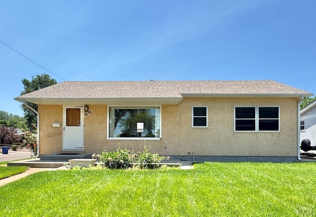 1645 Cherrywood Ln, Pueblo, CO 81005 - view of front of home with stucco siding, a front yard, and a shingled roof