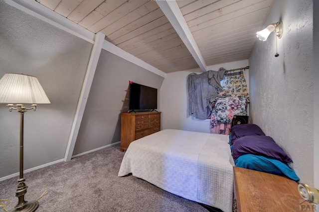 carpeted bedroom featuring beamed ceiling, baseboards, wood ceiling, and a textured wall