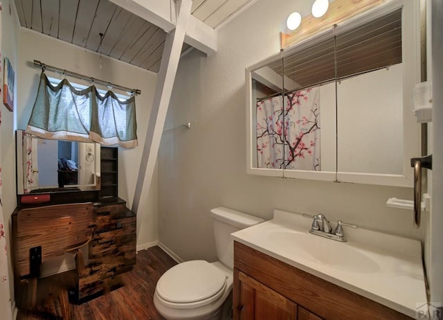 bathroom with baseboards, toilet, wooden ceiling, wood finished floors, and vanity