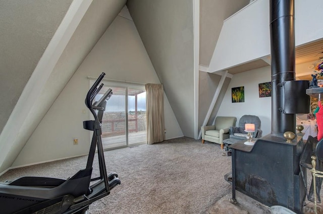 exercise area with lofted ceiling and carpet floors