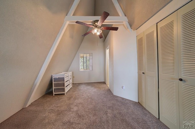 unfurnished bedroom featuring lofted ceiling with beams, carpet flooring, and a closet