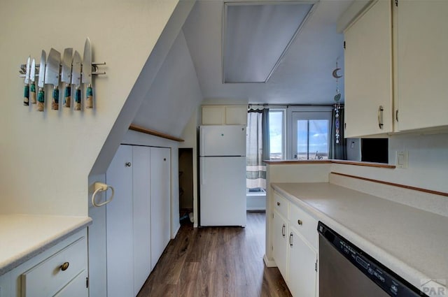 kitchen with dark wood finished floors, dishwasher, light countertops, freestanding refrigerator, and white cabinetry