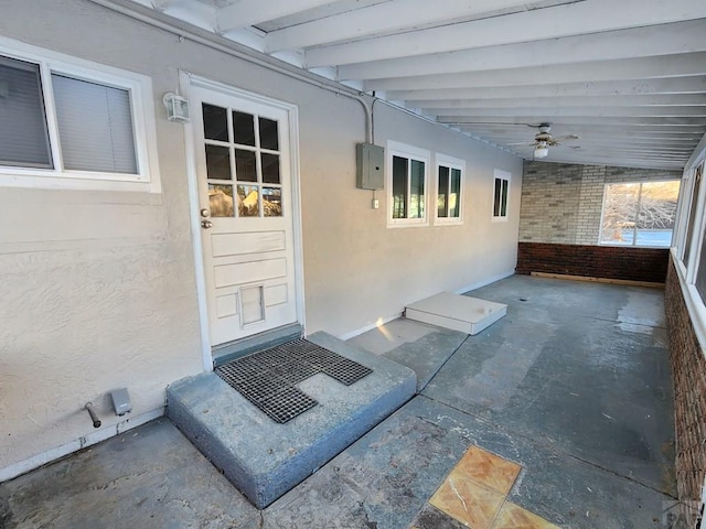 view of patio featuring a ceiling fan and electric panel