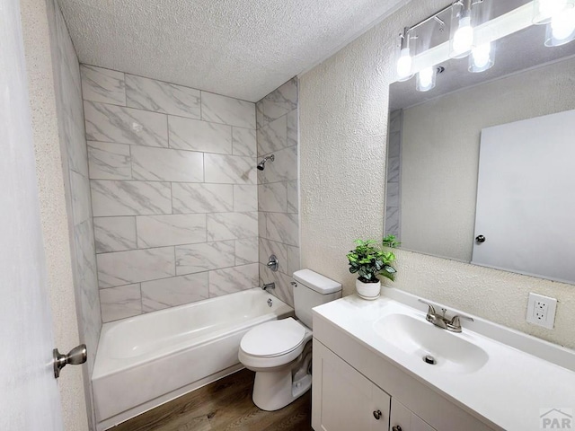 full bath with a textured wall, a textured ceiling, shower / tub combination, and wood finished floors