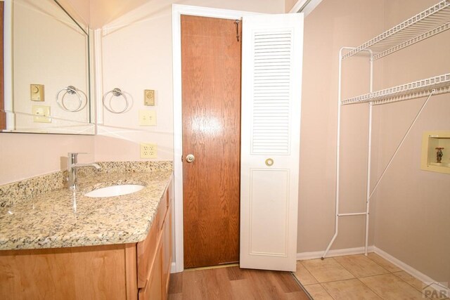 bathroom featuring vanity and wood finished floors