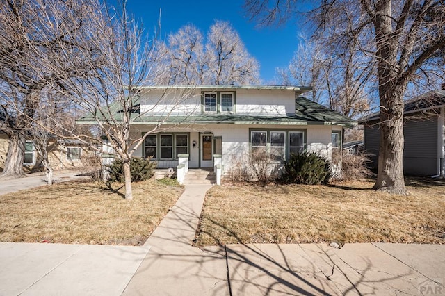 traditional-style home with a front yard