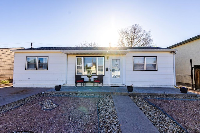view of front of home featuring a porch and fence