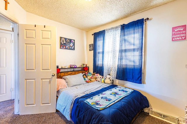 bedroom with carpet flooring, a textured ceiling, and visible vents