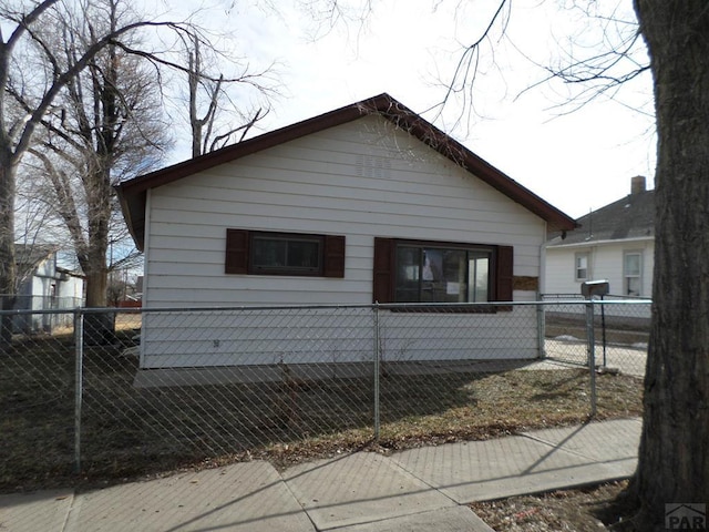 view of property exterior featuring a fenced front yard