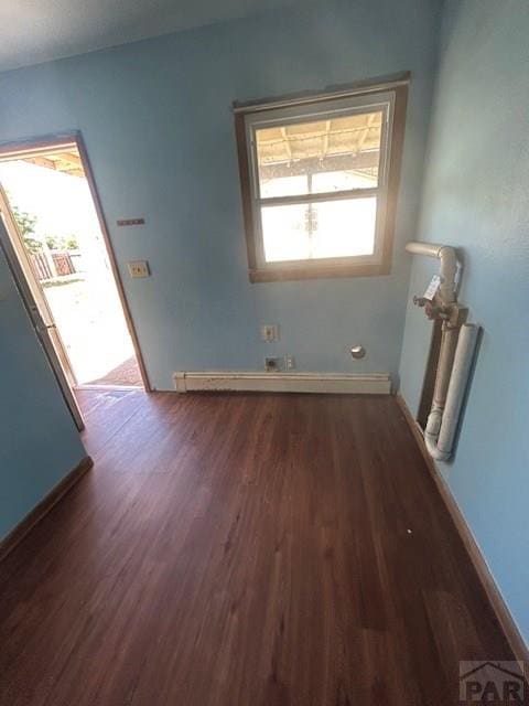 743 Vine Ave, Las Animas, CO 81054 - unfurnished room featuring wood finished floors, baseboards, and baseboard heating