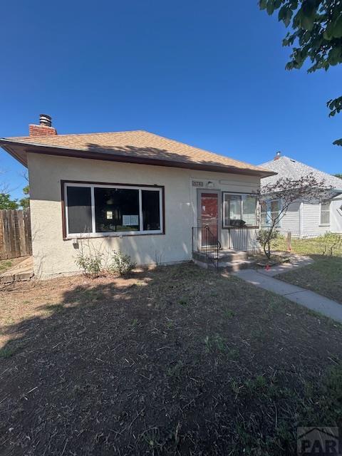 743 Vine Ave, Las Animas, CO 81054 - view of front of home with stucco siding and a chimney