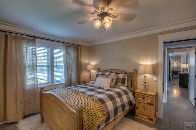 bedroom with crown molding, ceiling fan, and light wood-type flooring