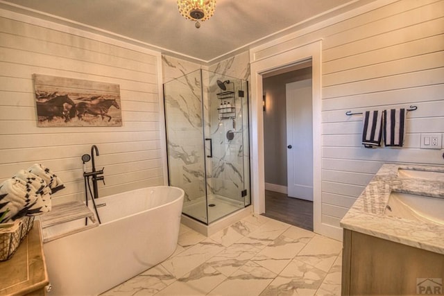 full bathroom with a marble finish shower, wood walls, marble finish floor, a freestanding bath, and double vanity
