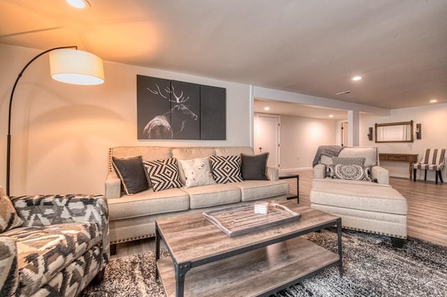 living room with recessed lighting and wood finished floors